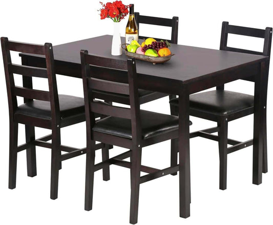 A modern dining set with a rectangular table, four black chairs, and a decorative fruit bowl.