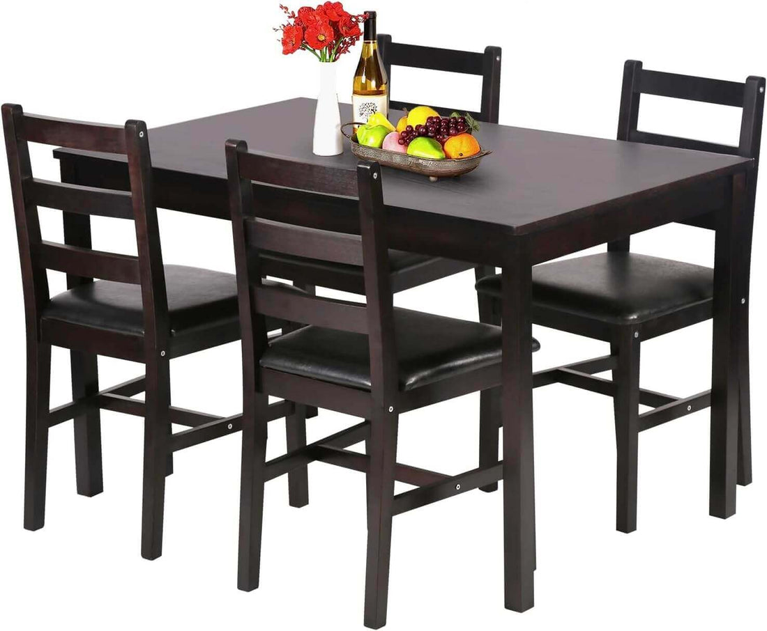 A modern dining set with a rectangular table, four black chairs, and a decorative fruit bowl.