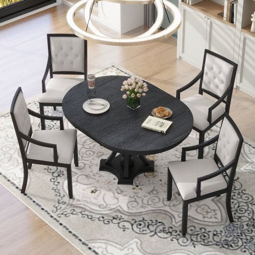 Elegant black and white dining set on a decorative rug in a sophisticated dining room