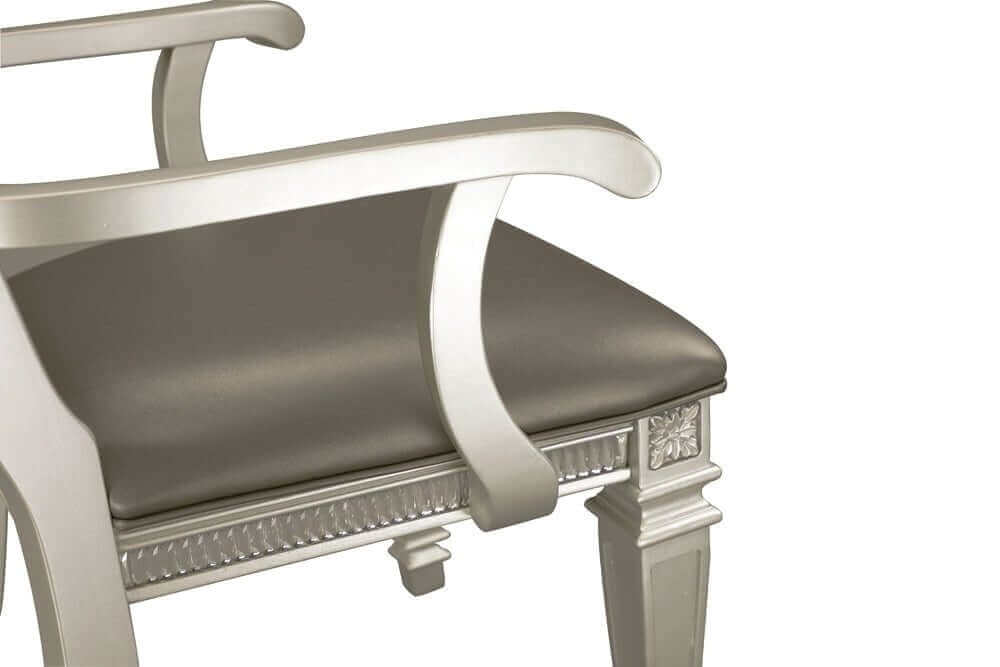 Close-up of a silver finish armchair with crystal-tufted detailing from a 7-piece dining set.