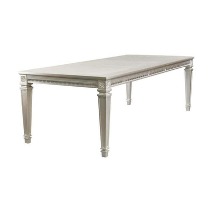 Silver finish dining table with removable leaf for versatile dining setup. Elegant and modern design for dining rooms.