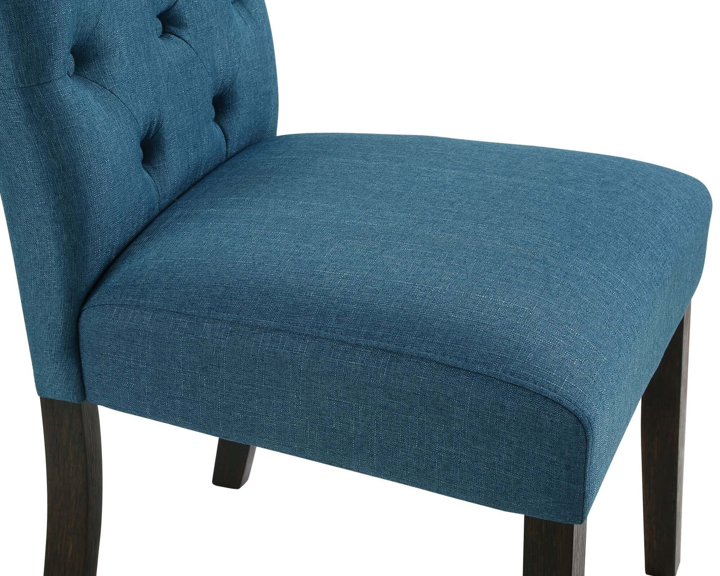 Close-up of a stylish blue upholstered chair with tufted back and dark wood legs, ideal for dining room aesthetics.