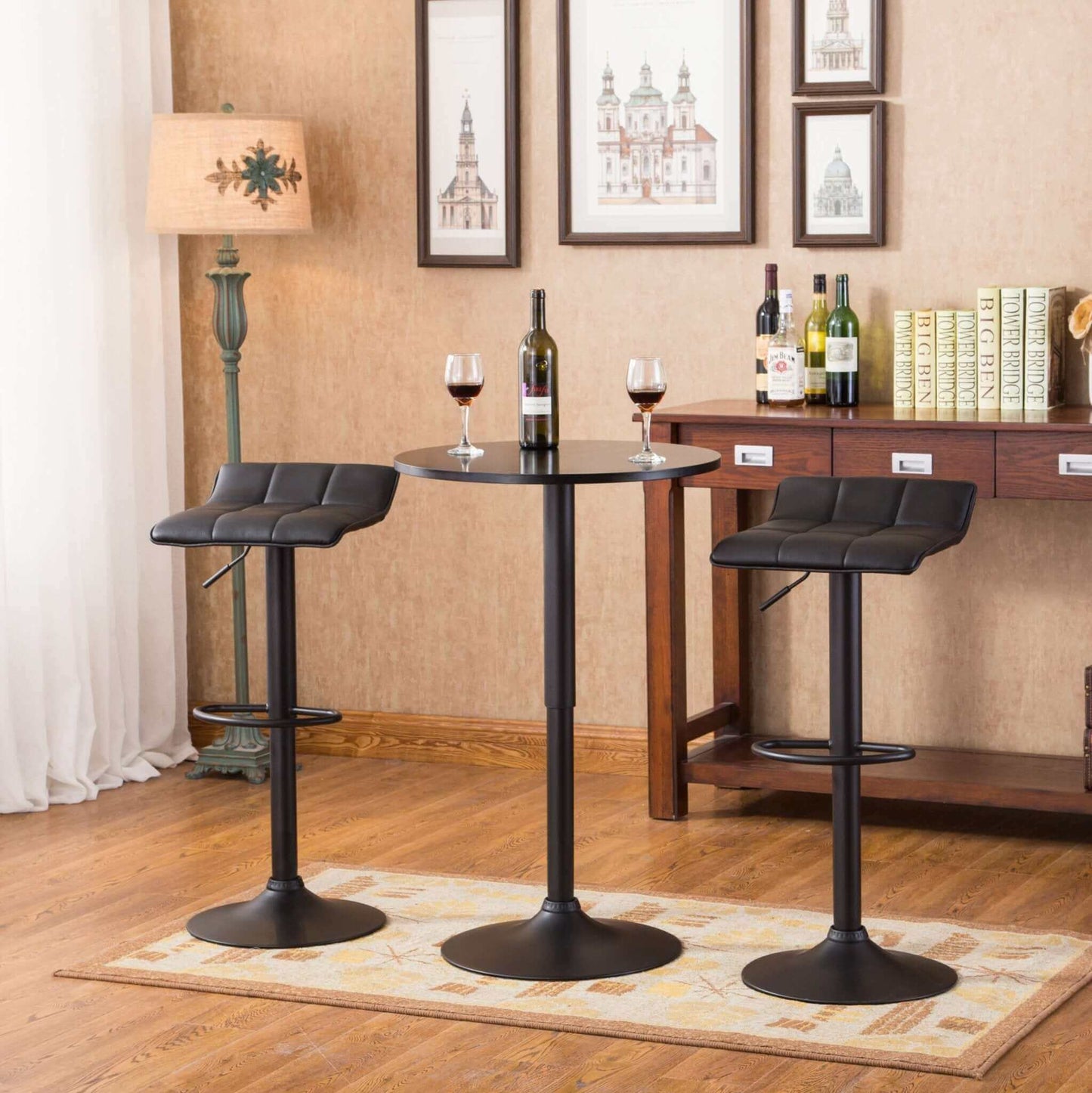 Belham black adjustable height bar table with two swivel stools in dining room setting