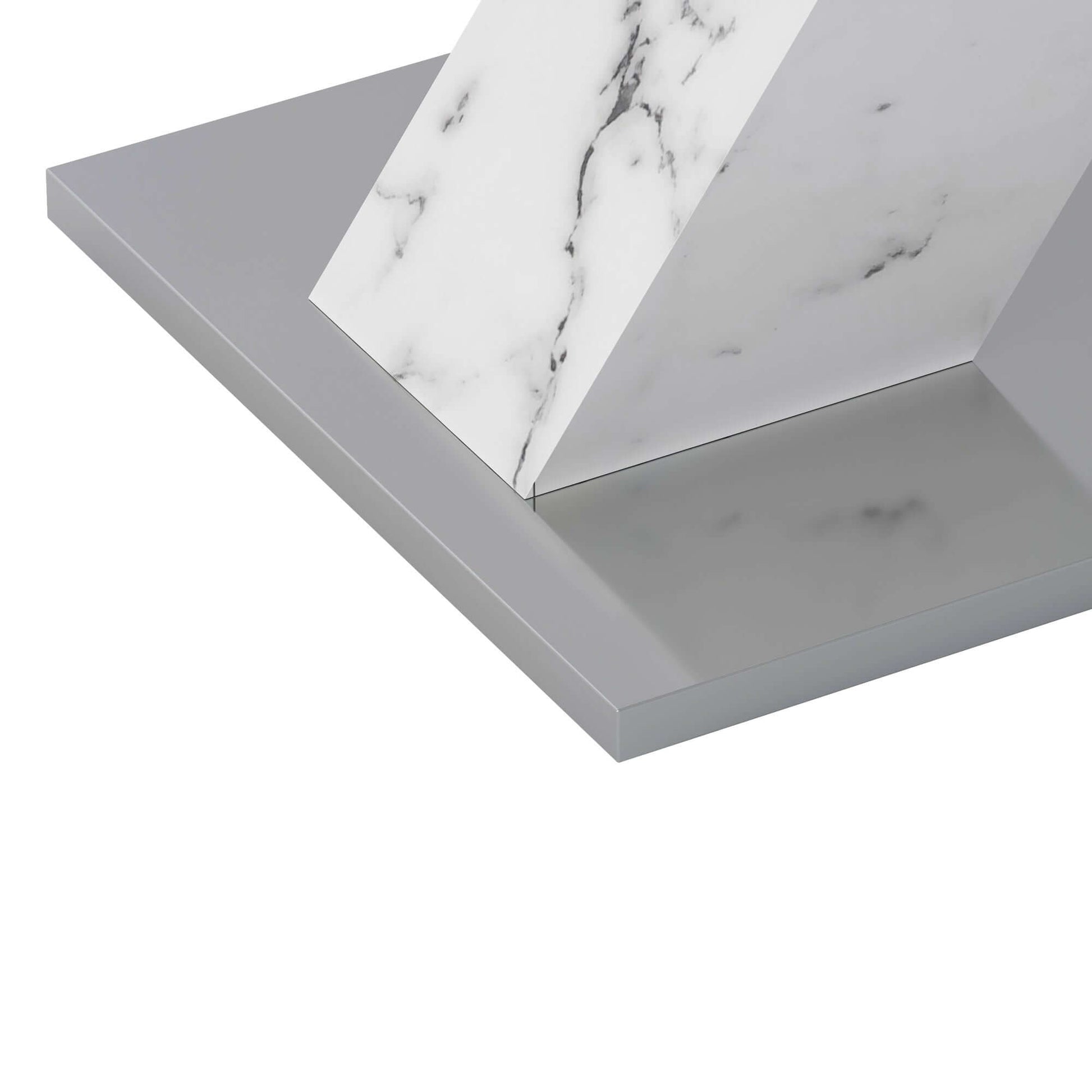 White marble and metal base of modern dining table showing stretchable design.