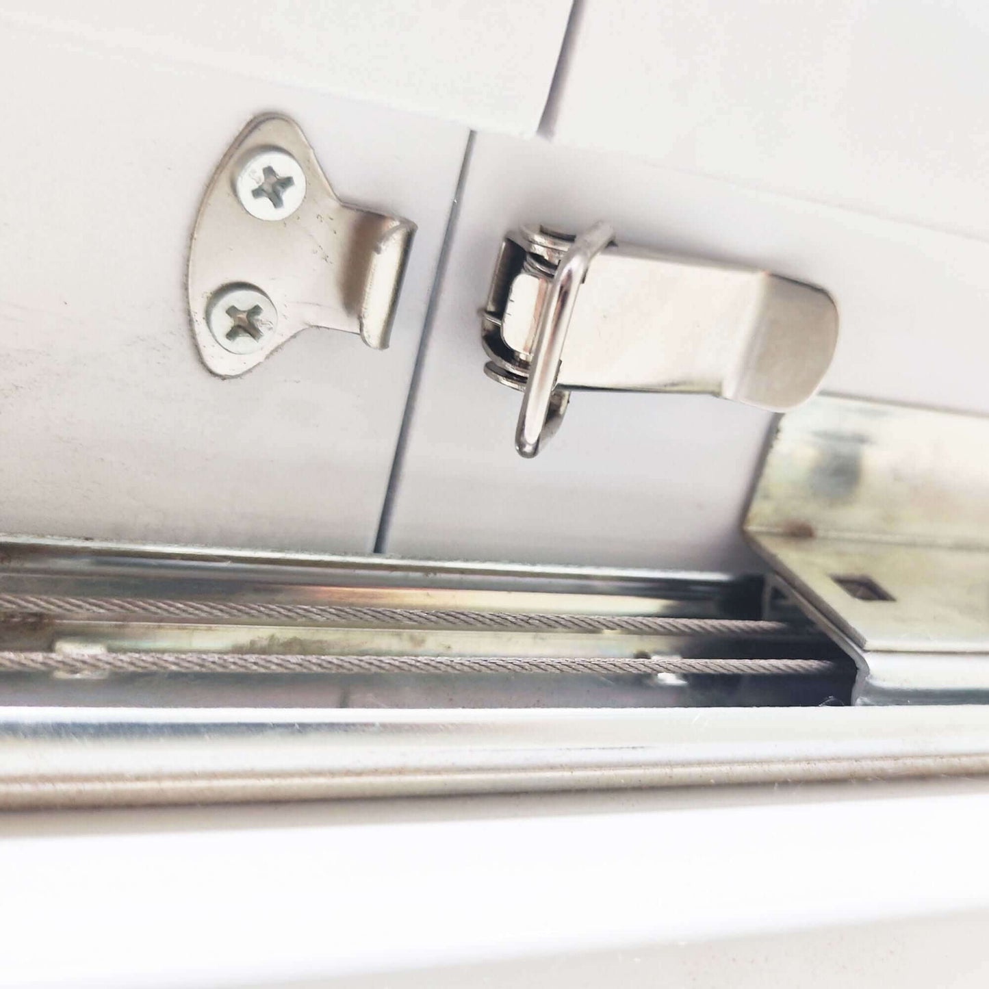 Close-up of a metal hinge mechanism on the Modern Square Dining Table.