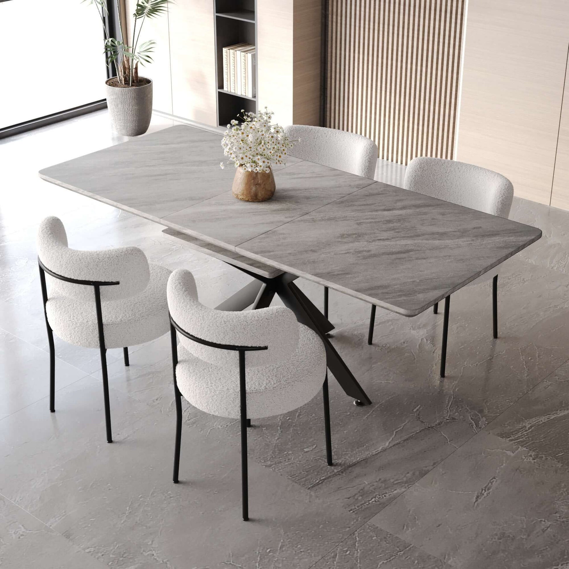 Extendable dining table set for 4 with grey marble-like tabletop and curved backrest round upholstered white padded armless chairs in modern dining room