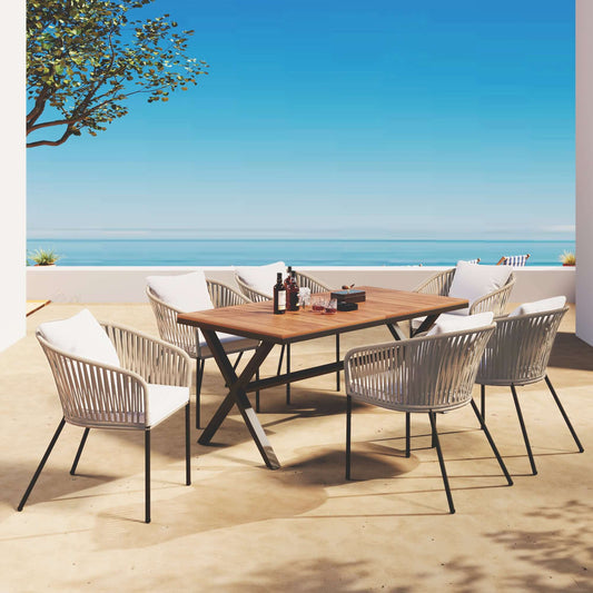 7 pieces beige patio dining set with acacia wood tabletop, metal frame chairs, and cushions on outdoor terrace overlooking the ocean