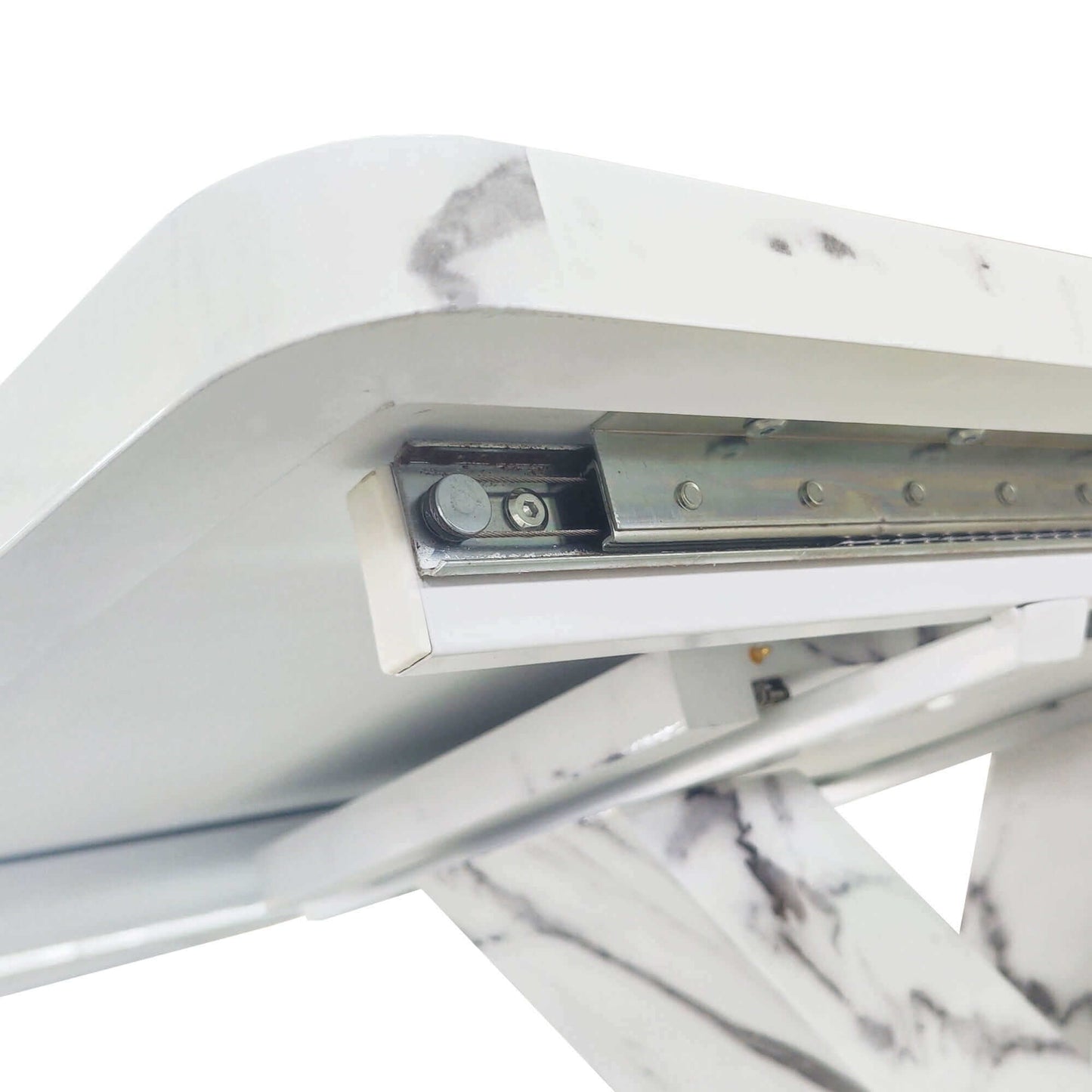 Close-up of stretchable mechanism on modern white marble dining table with metal base.