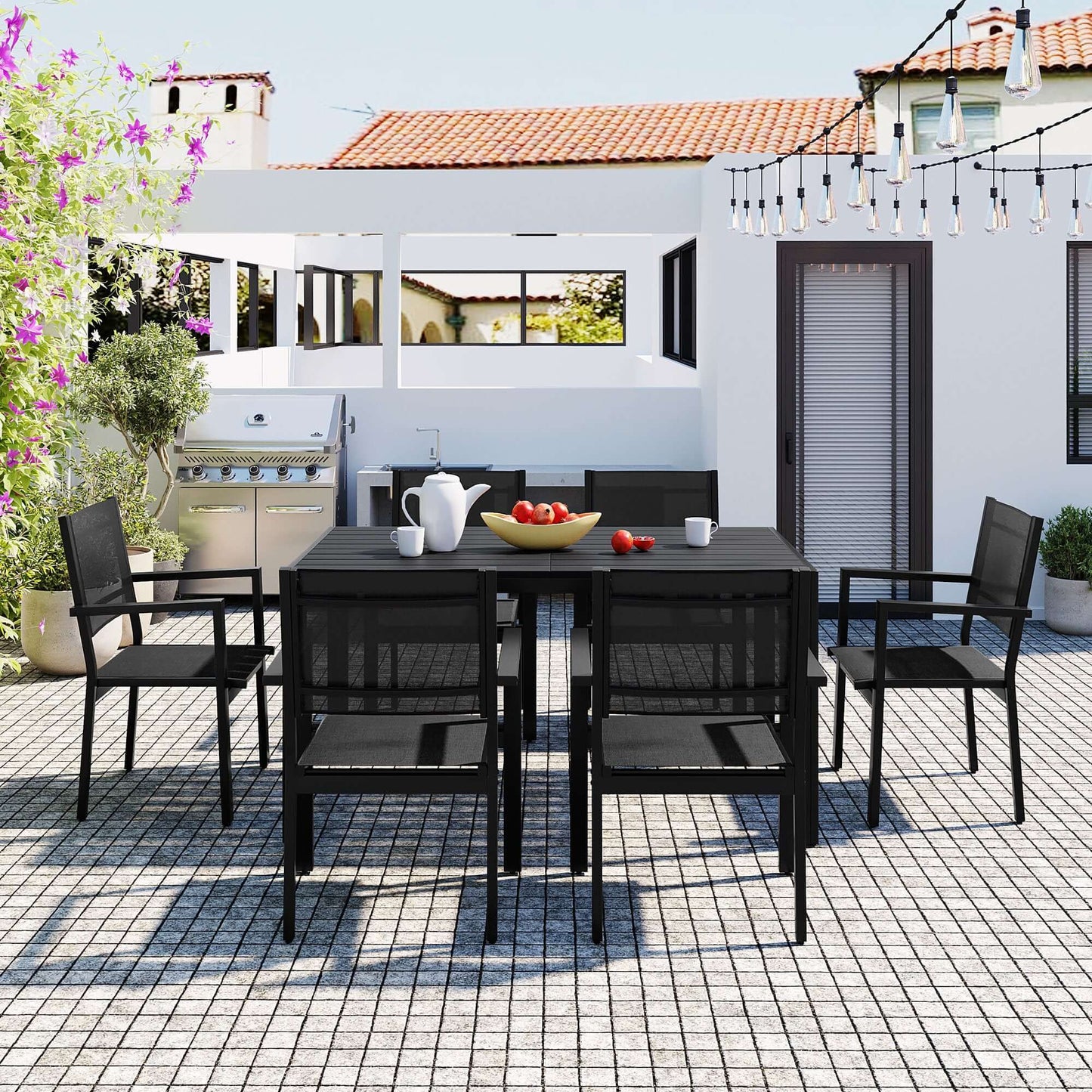 Outdoor patio with U-Style high-quality steel table and chairs set for six, black color, including decorative plants and string lights.
