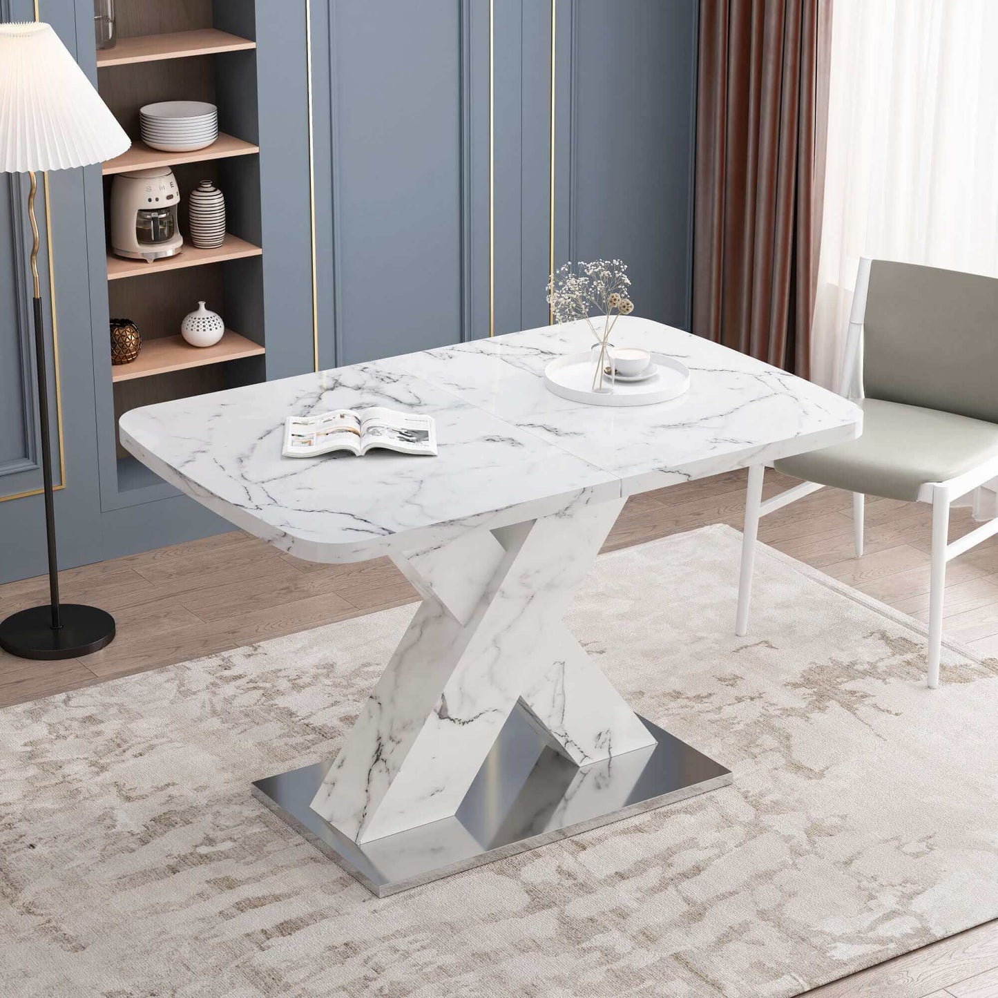 Modern stretchable white marble dining table with metal base in an elegant dining room setting.