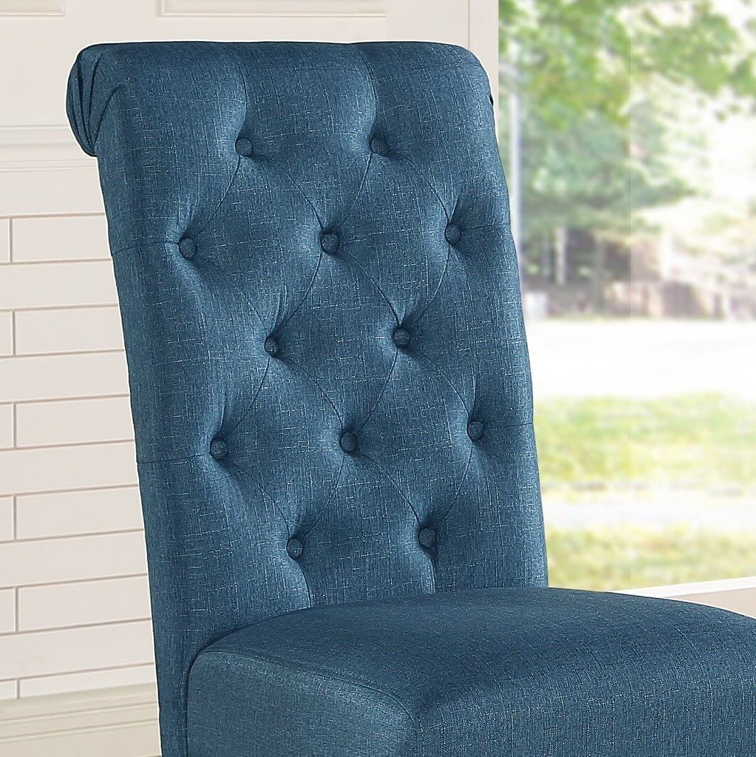 Close-up of a tufted blue dining chair showcasing elegant upholstery and design details.