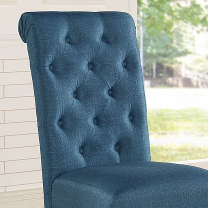 Close-up of a tufted blue dining chair showcasing elegant upholstery and design details.