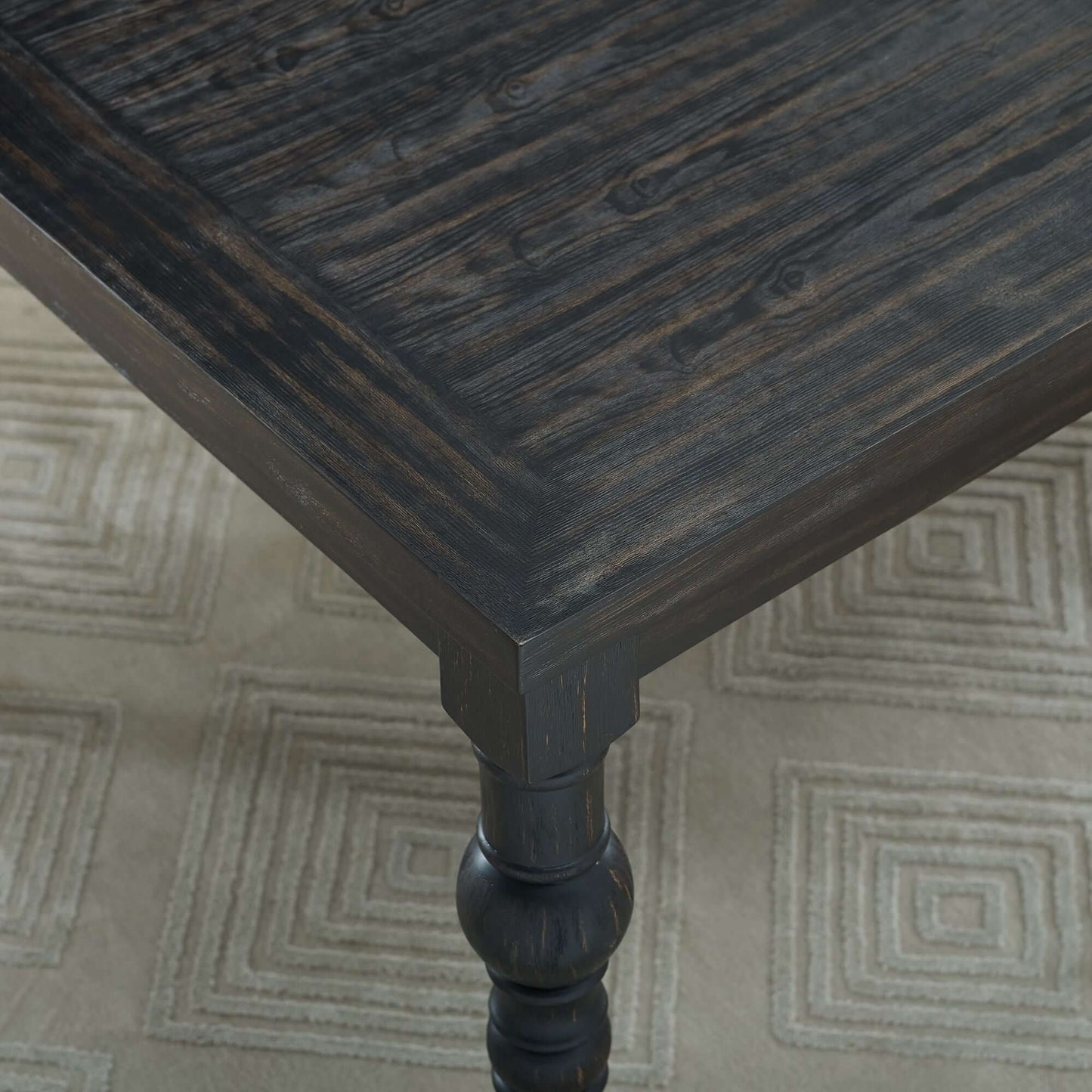 Close-up of Leviton Urban Style dark wash wood dining table showcasing elegant texture and design.
