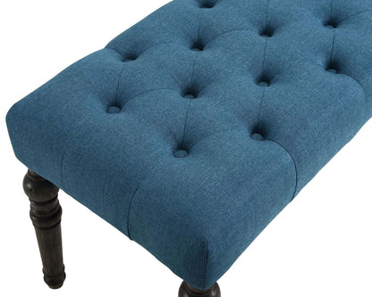 Close-up of a tufted blue upholstered bench with dark wooden legs, perfect for modern seating or decor.