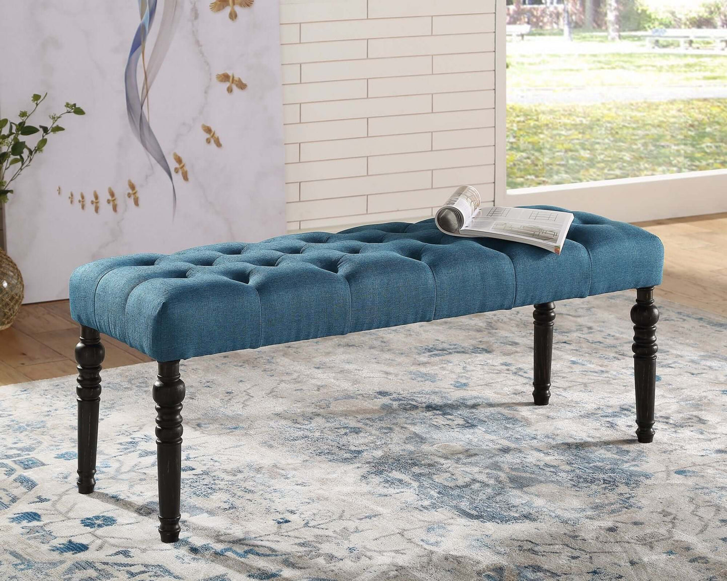 Stylish tufted teal bench with black legs, perfect for adding seating and elegance to your dining or living space.