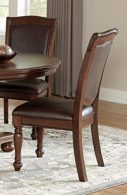 Traditional style brown cherry dining table and side chairs in a dining room setting.