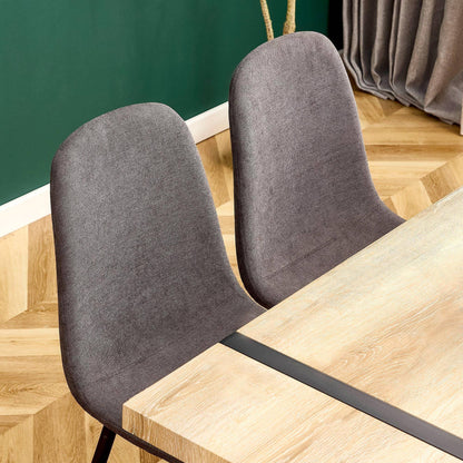 Dark gray modern medieval style chairs at a wooden dining table in a stylish interior setting.